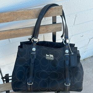 Black coach purse with satin purple interior